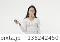 Young adult woman smoking an electronic cigarette white background isolated space 138242450