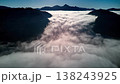 Stunning aerial hyperlapse of fog cascade rolling down mountain valley 138243925