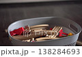 Child Hand Placing Wooden Train Tracks In Grey Basket On Hardwood Floor, Morning Light, Cozy Playroom, Small 138284693