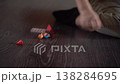 Small Hands Manipulating Wooden Train Pieces On Dark Floor, Fine Motor Practice, Focused Dexterity And Careful 138284695