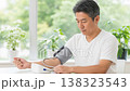 Middle-aged man having his blood pressure measured; lifestyle-related diseases and health check. Middle-aged man having his blood pressure measured; lifestyle-related diseases and health check. 138323543