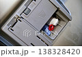 Detergent compartment loading process in dishwasher, visible soap pods 138328420