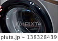 Close-up of closing the door washing machine door with clothes, hand touching glass surface 138328439