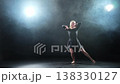 Contemporary woman dancer posing on black background with smoke. Adult female artist performer dancing with expression. Modern ballerina dancing in darkness. Passion dance in dark. Flexibility balance 138330127