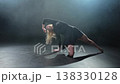 Contemporary woman dancer posing on black background with smoke. Adult female artist performer dancing with expression. Modern ballerina dancing in darkness. Passion dance in dark. Flexibility balance 138330128