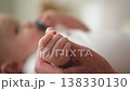 Happy family. Tiny newborn infant baby little hand on mother hand palm. Newborn baby holding parent finger after birth. Mom baby at home. Support protection of new life. Handle with care 138330130