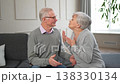 Senior adult mature couple talking at home. Mid age old husband and wife speaking smiling laughing enjoying time together. Grandmother grandfather spending time together. Family moment love and care 138330134