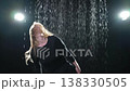 Contemporary woman dancer posing in rain water on black background. Female artist performer dancing with expression. Modern ballerina dancing in darkness. Passion dance in dark. Flexibility balance 138330505