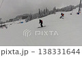 A Skier Gliding Down a Freshly Snow-Covered Slope at a Winter Mountain Resort 138331644