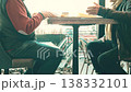 Two unrecognizable senior men talking while seated at a cafe table near a window 138332101