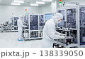 Workers in clean suits working in a precision machinery factory Workers in clean suits working in a precision machinery factory 138339050