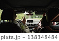 Father and daughter having fun, singing and dancing together inside a car during a road trip, joyful moments and bonding on the journey. 138348484