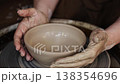 Creating a simple pottery bowl on a potter's wheel with hands 138354696