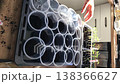 a woman is engaged in growing seedlings. she adds soil to plastic cups. nearby in a container are green seedling sprouts. vertical video. 138366627