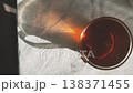 Cup Of Tea In Sunlight Casting Warm Reflection On Fabric 138371455