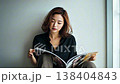 Japanese woman reading a magazine 138404843
