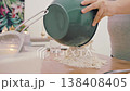 The hands of a female cook knead a lump of dough on a wooden table with white wheat flour. High quality 4k footage 138408405