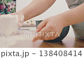 The hands of a female cook knead a lump of dough on a wooden table with white wheat flour. High quality 4k footage 138408414