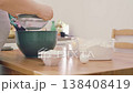 The hands of a female cook knead a lump of dough on a wooden table with white wheat flour. High quality 4k footage 138408419