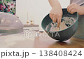 The hands of a female cook knead a lump of dough on a wooden table with white wheat flour. High quality 4k footage 138408424