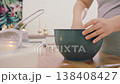 The hands of a female cook knead a lump of dough on a wooden table with white wheat flour. High quality 4k footage 138408427