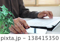 Image of a man working remotely in a brightly lit room (focus on the foreground, face not visible) - Smartphone 138415350