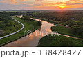 Top down view drone footage of Labuh Banting river winding through fields at sunset. 138428427