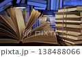 Open book with stacked volumes in warm light learning concept 138488066