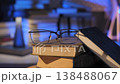 Eyeglasses on stacked books in soft light study environment 138488067