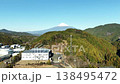 Drone footage showing a bird's-eye view of Mount Fuji as it ascends from near the Shin-Shimizu Interchange. 138495472