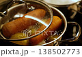 Carrots and potatoes are boiling in a pot, releasing steam and making a nutritious dish perfect for a healthy dinner. 138502773