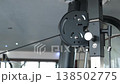 Close examination of a gyms pulley system, showcasing the mechanics of strength training equipment used for workouts and fitness routines. 138502775