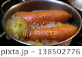 Carrots and potatoes are being boiled together in a pot, creating a nutritious meal option that is simple and delicious. 138502776
