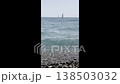 Sailboats near rocky beach in bright sunlight 138503032