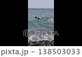 Swimmer enjoys the ocean at a rocky beach 138503033