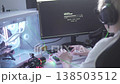 A teenage boy uses ChatGPT on a computer, typing on a keyboard in a modern home setup, exploring 138503512