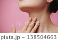 Young beautiful woman with clean skin close up touching slowly and tenderly her neck on a pink background. Concept of skin care for health and beauty 138504663