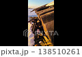Snow melts on the roof, drops of water fall to the ground. Spring thaw. Spring mood. 138510261