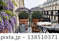 Paris balcony lavender corner with open book and glass of water, terracotta pots and wisteria spilling over patterned mosaic tiles writers 138510371