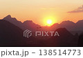 Hot air balloon flying over mountains in Vang Vieng, Laos during golden sunset, creating travel and adventure concept 138514773