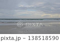 Peaceful video of a deserted Andaman beach featuring smooth, wet sand reflecting the overcast sky while looking out at the Indian Ocean horizon. 138518590