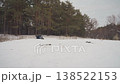 Atv charging toward camera through snow headlights blazing, frontal perspective, tire spray throwing powder, intense engine tone, driver controlling comeback, final lap energy, pine forest backdrop, 138522153