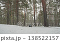 Snowy ATV adventure. Excited driver expertly maneuvers across snowladen pine landscape with power. Energetic ATV rider skillfully skillful steering through frosty forest filled with snow and pine 138522157