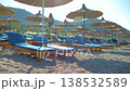 Beach resort with wooden sunbeds and parasols 138532589