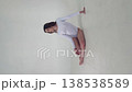 Graceful dancer in white leotard performs in studio 138538589