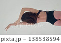 Elegant Woman Dancing in Black Leotard on White Background 138538594
