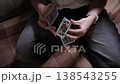 A man with a deck of cards in his hands put on a card show. His hands move very dexterously with a deck of cards. Top camera view. Extreme close up shot 138543255