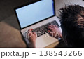 A teenager sits on a sofa and typing on laptop. He is writing software code, his fingers very quickly work on keyboard. Camera view above to boy. Big close up shot 138543266