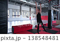 An athletic man practices at a ninja club's indoor obstacle course. 138548481