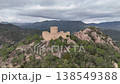 Mountain Castle in Spain. Drone footage showcases this historical site. Surrounded by lush greenery and scenic mountains, it offers breathtaking views. A perfect location for exploration. 138549388